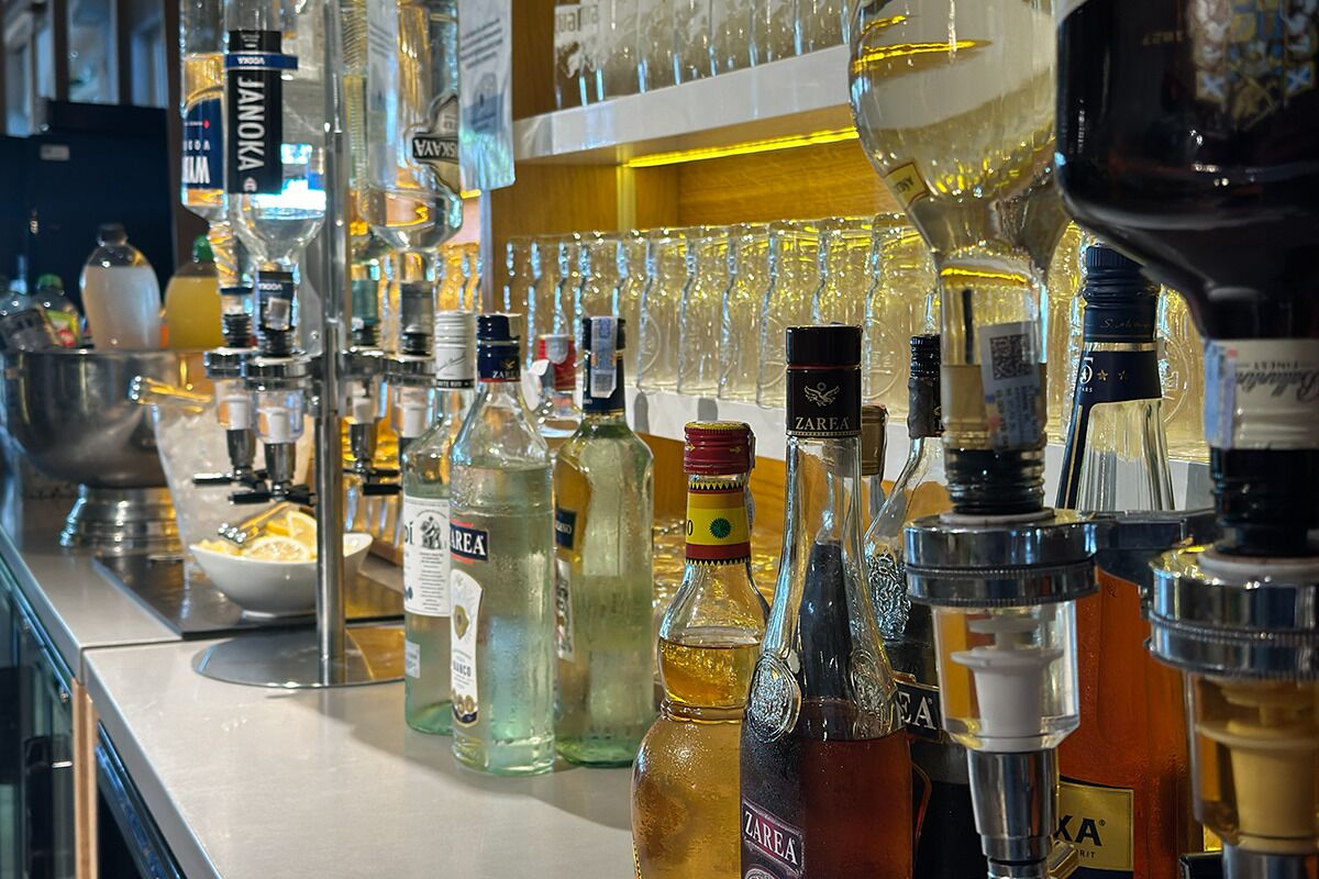 A bar with various liquor bottles and glasses.