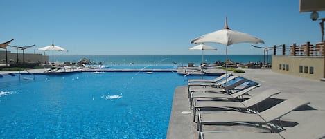 Outdoor pool, pool umbrellas, sun loungers