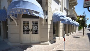 A hotel facade with a blue awning labeled "HOTEL VILLA BERNT." - Hotel Villa Bernt (Grado)