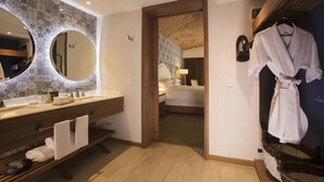 A modern bathroom with a wooden vanity, a large mirror, and a towel rack. - The Hacienda at Krystal Grand Puerto Vallarta (Puerto Vallarta)