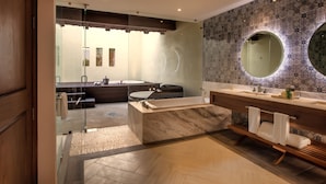 A modern bathroom with a large bathtub, a separate shower area, and a vanity with a mirror. - The Hacienda at Krystal Grand Puerto Vallarta (Puerto Vallarta)