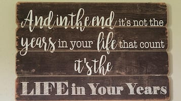 A wooden sign with a motivational quote.