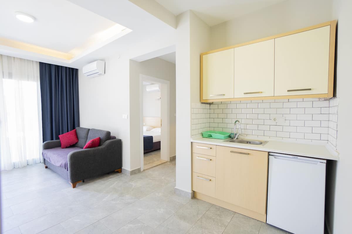 A modern kitchen with white cabinets, a dishwasher, and a countertop.
