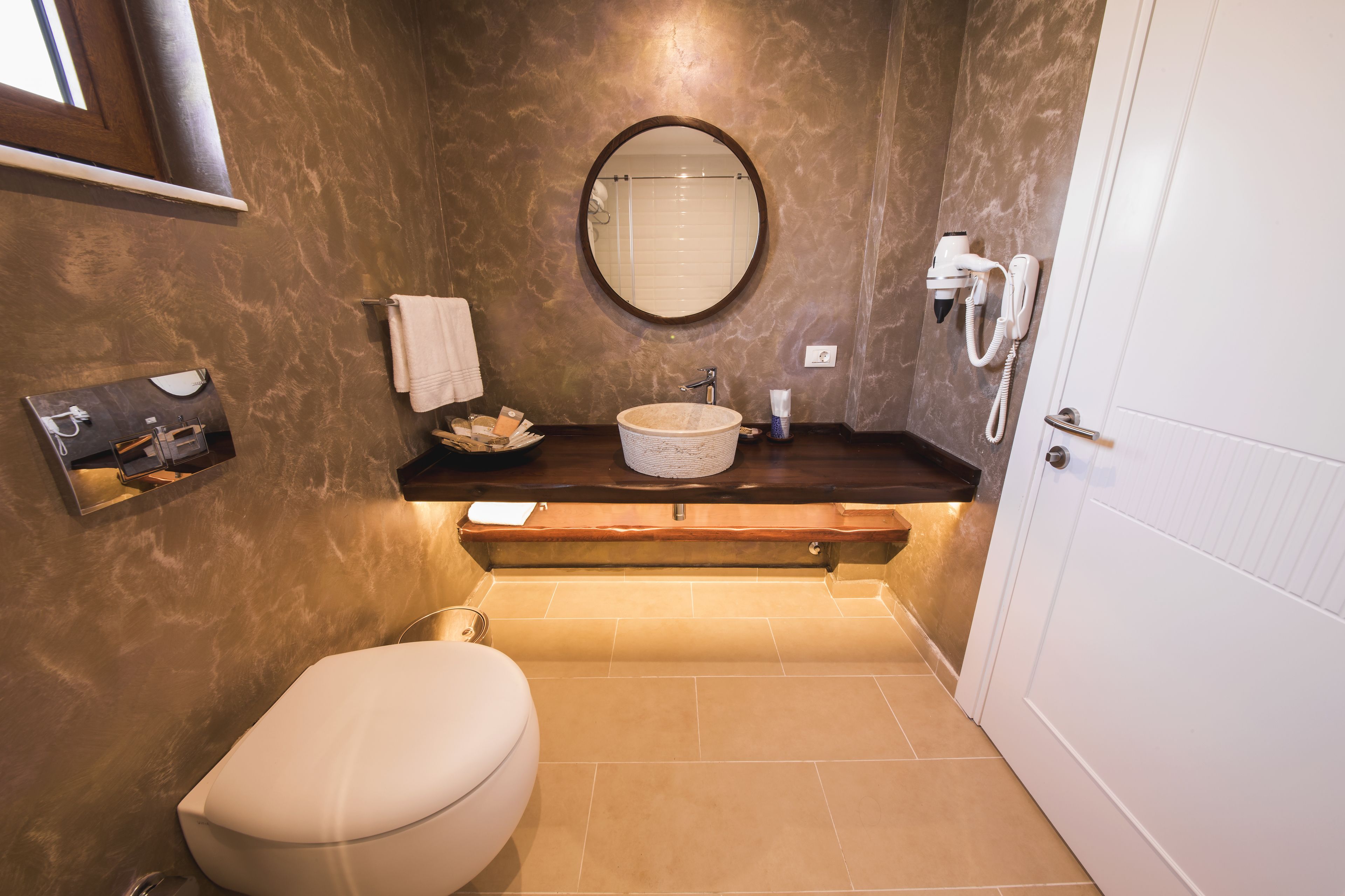 designer toiletries, hair dryer, slippers, towels