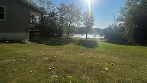 A house with a deck and a view of a lake.