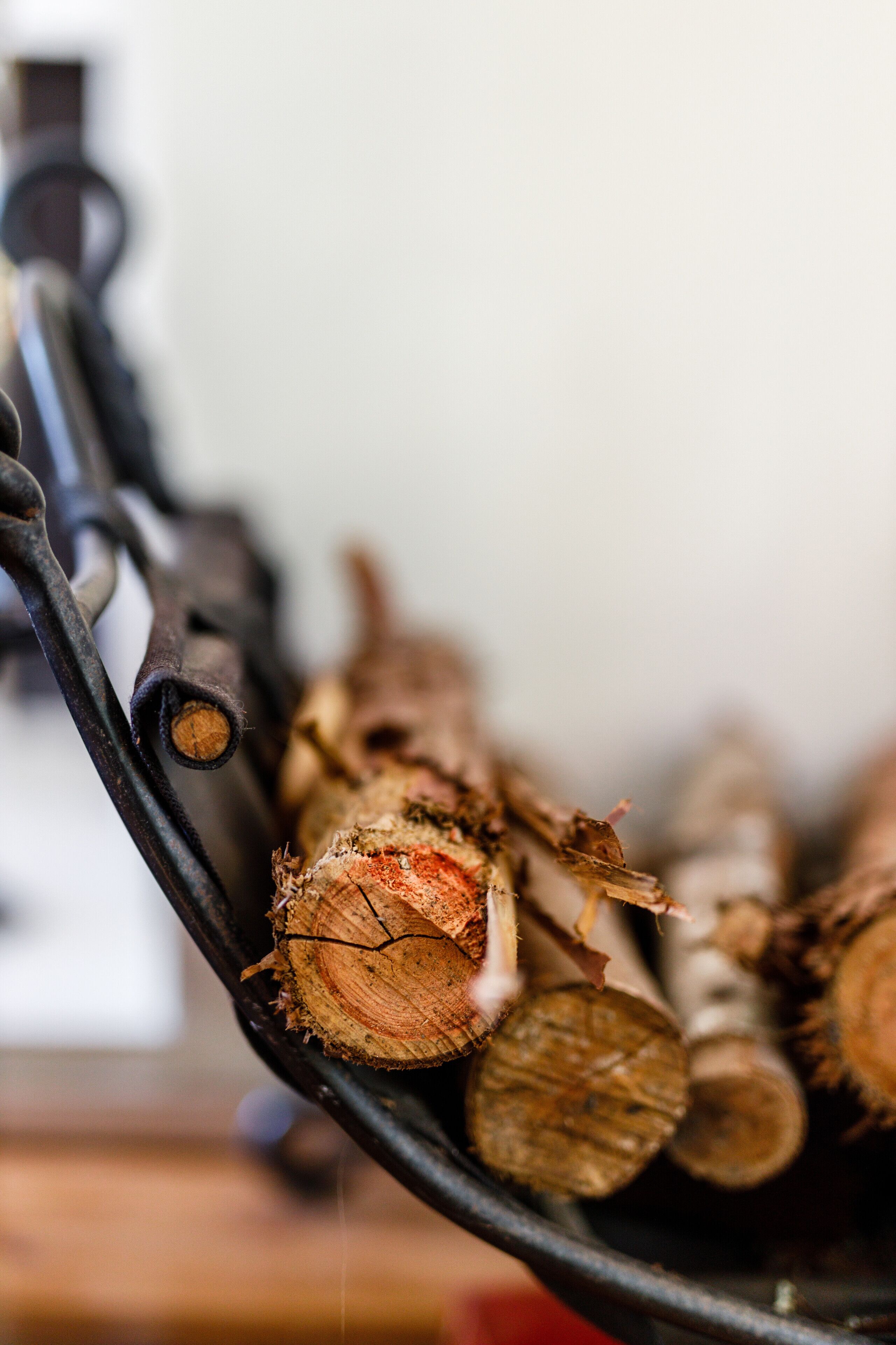 A close-up of a metal rack holding several logs.