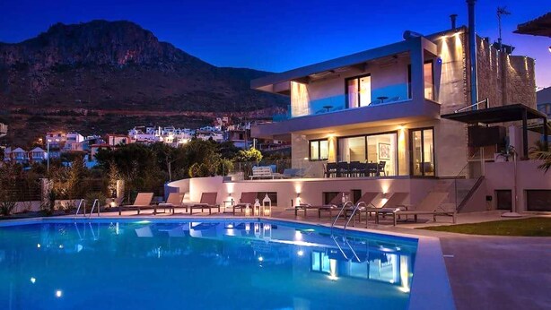 A modern hotel with a pool, lounge chairs, and a mountain view. - Orama Luxury Villa, 4 Bedrooms with Private Pool, Sleeps 8 (Piskopiano)
