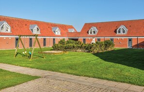 Guests can enjoy a serene courtyard with a lawn, swing set, and garden.