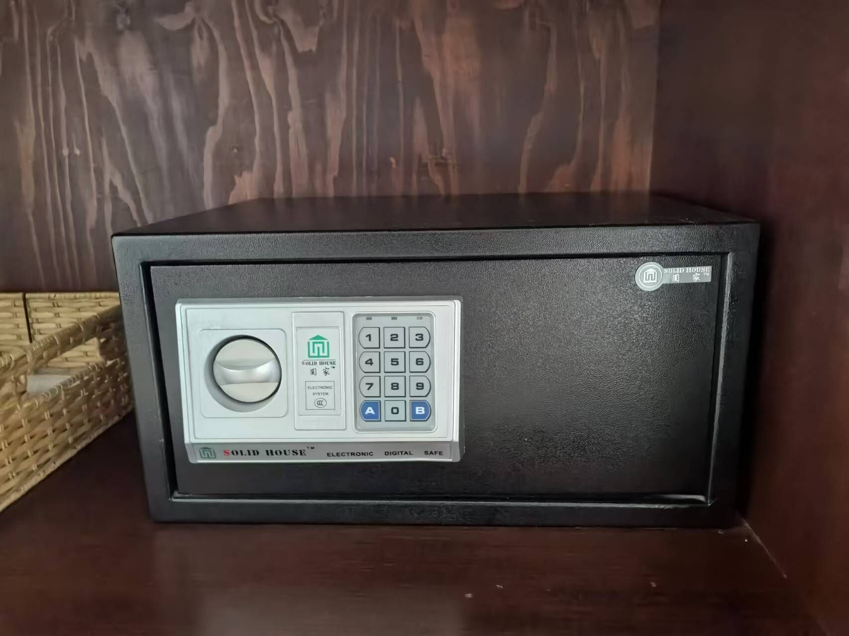 A black safe with a keypad and a digital lock.