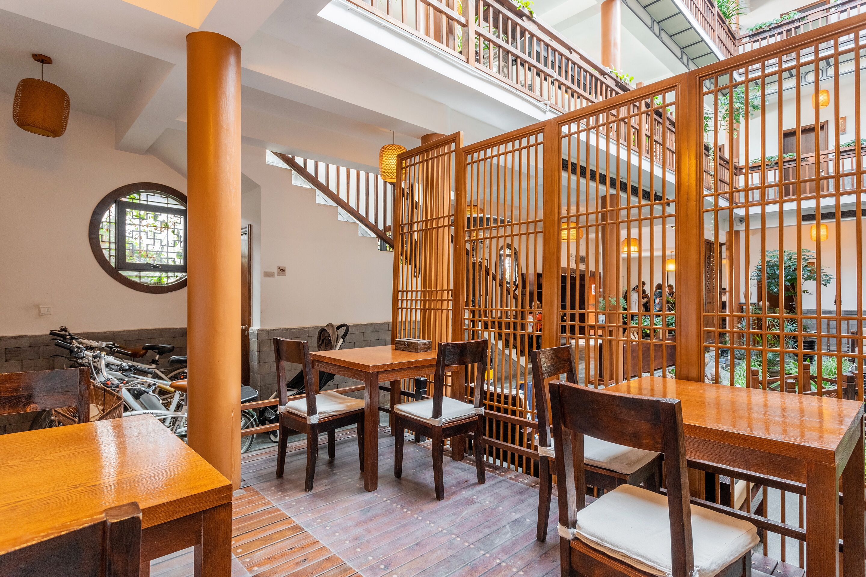 A restaurant with wooden furniture and a staircase.