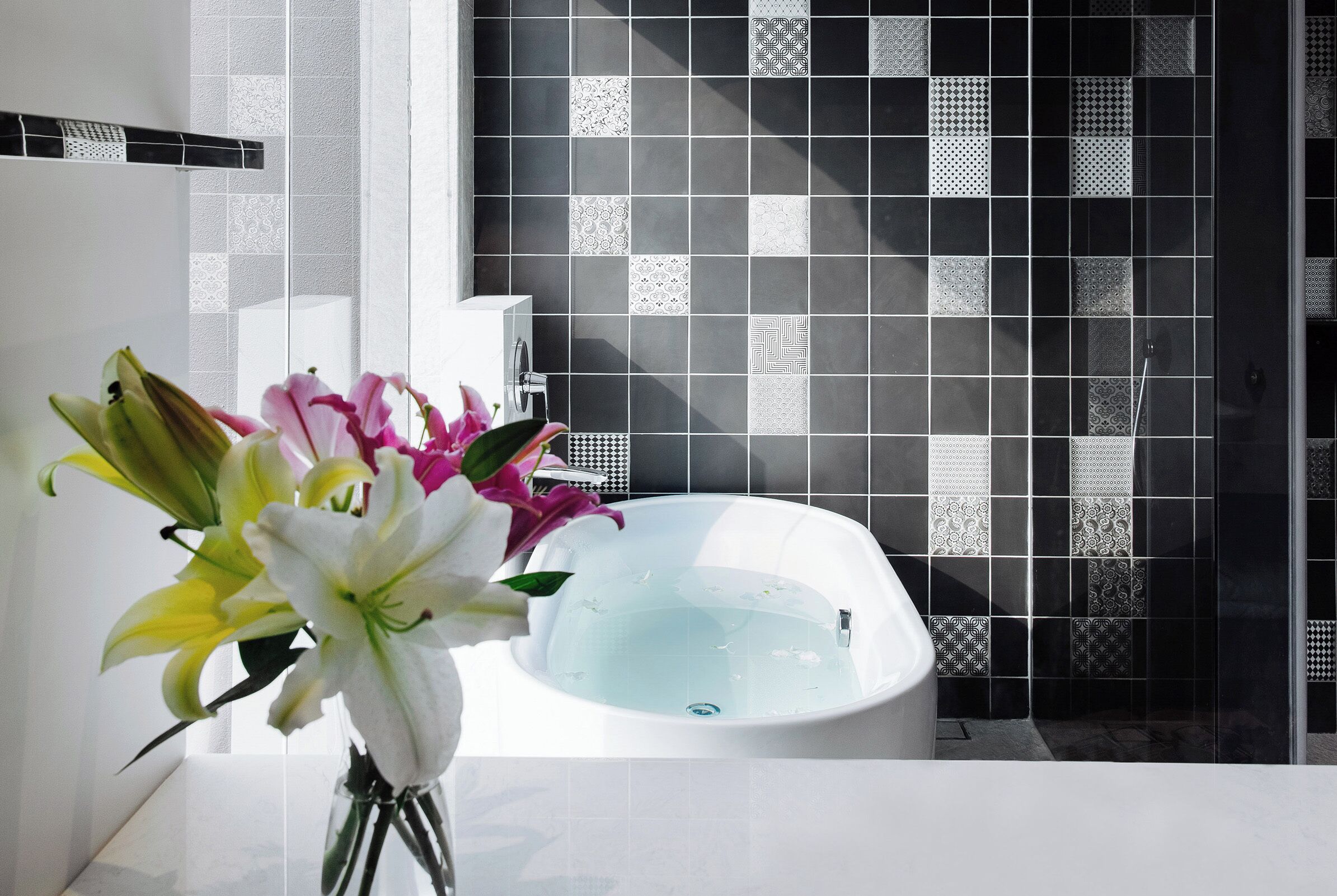 deluxe family suite | bathroom | hair dryer, towels, shampoo, toilet paper