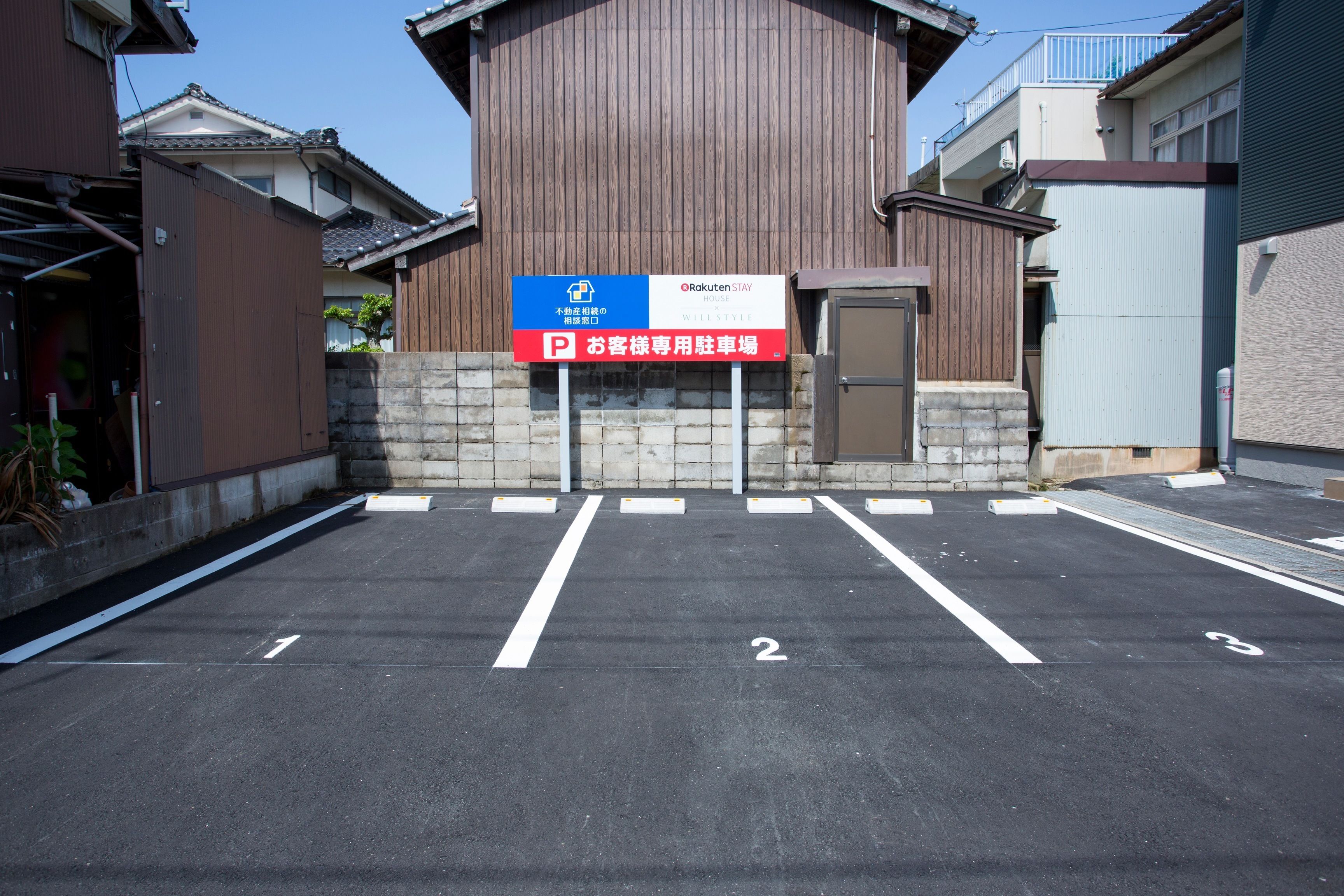 A parking lot with numbered spaces and a sign indicating a parking area for guests.