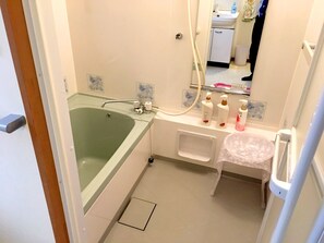 A bathroom with a bathtub, a sink, and a toilet. - Koto Hananobou (Kyoto)
