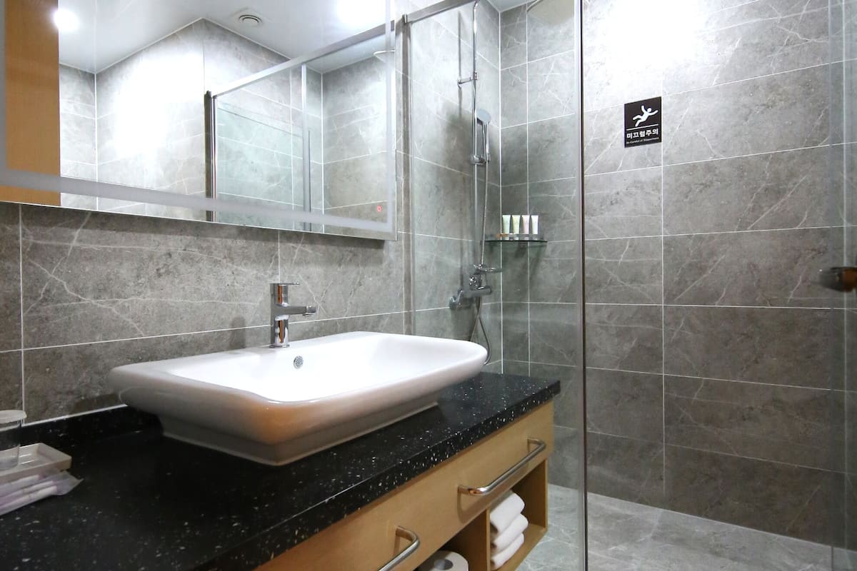 hair dryer, slippers, bidet, towels