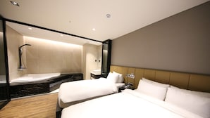 A hotel room with two beds, a shower area, and a bedside telephone. - Sea Cruise Hotel (Sokcho)