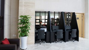 A modern office space with a reception area, a potted plant, and multiple workstations. - Sea Cruise Hotel (Sokcho)