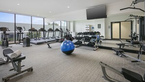 A gym with cardio machines, weightlifting equipment, and a large exercise ball. - Quest Notting Hill (Notting Hill)
