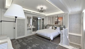A modern bedroom with a large bed, a chandelier, and a view of the bathroom. - City Inn OCT Loft Branch (Shenzhen)