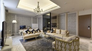 A modern living room with a sofa set, a coffee table, a TV, and a chandelier. - City Inn OCT Loft Branch (Shenzhen)