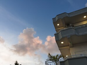 A multi-story building with a balcony and a visible door number. - Clear Water Hotel (Saipan)