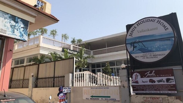 A building with a sign for 'Jesus Holiday Home' and a 'bazaar' sign. - Jesus Holiday Home Resort (Candolim)