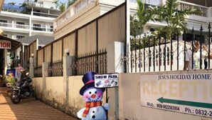 A snowman decoration with a sign that reads "Snow Park" and a partially visible sign for "Jesus Holiday Home" with a phone number. - Jesus Holiday Home Resort (Candolim)