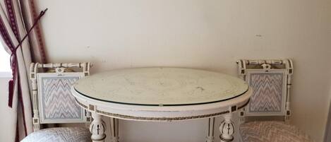 A round table with two chairs, each with a zigzag patterned cushion.