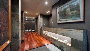 A modern bathroom with a wooden floor, a sink with a marble countertop, and a framed painting on the wall. - Hananobou Kinkakuji-michi (Kyoto)