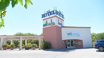 A hotel with a prominent sign reading "HOTEL HOTEL" and "BRIT HOTEL" on the facade.