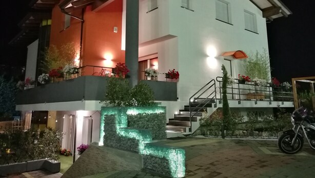A modern two-story house with a balcony, a staircase, and a motorcycle parked outside. - B&B Cristiano (Rende)