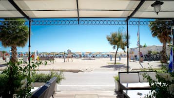 On the beach, white sand, sun-loungers, beach umbrellas