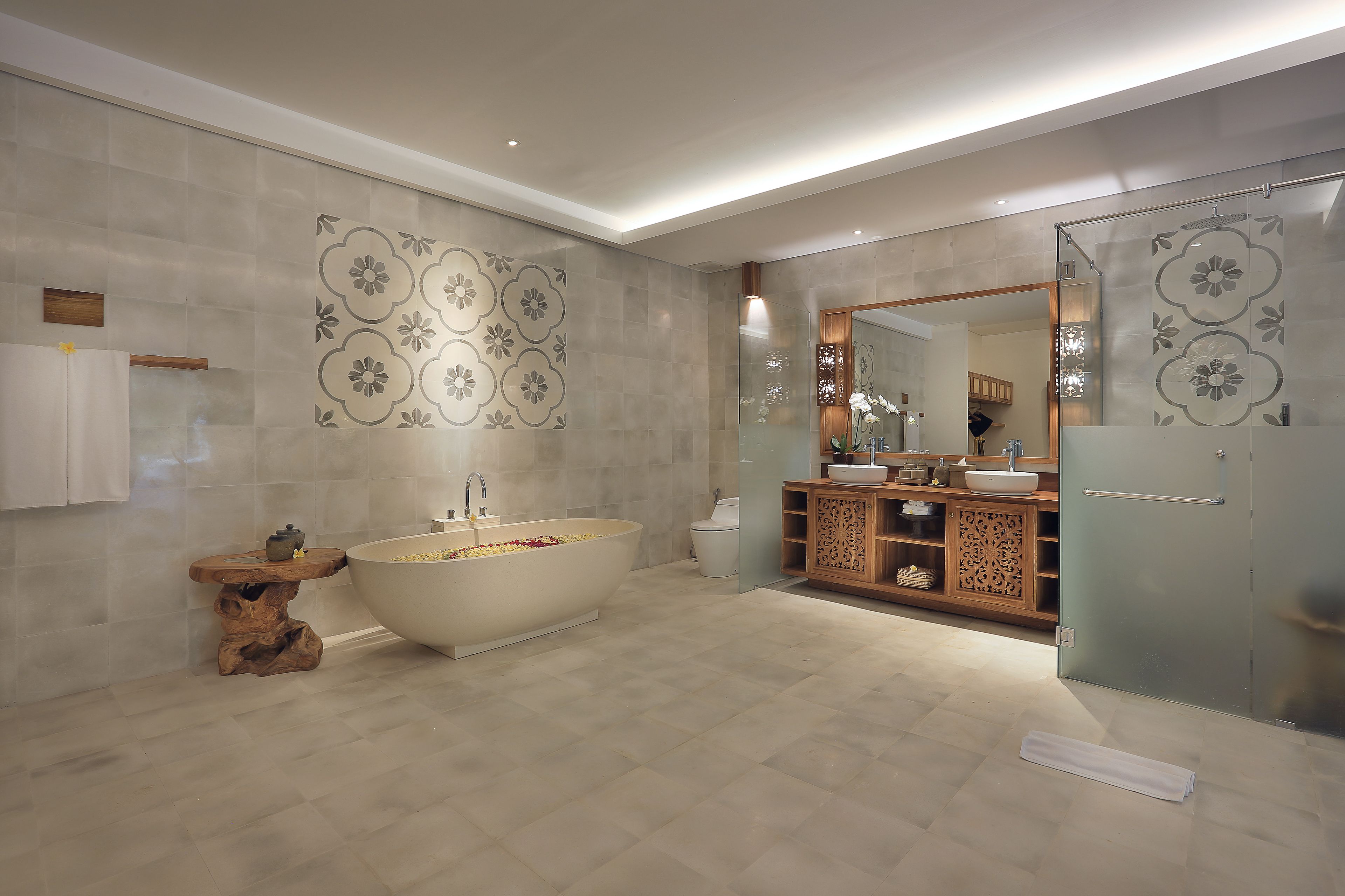 A modern bathroom with a freestanding bathtub, a wooden vanity, and a large mirror.