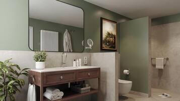 A bathroom with a vanity, a mirror, a toilet, and a shower area.