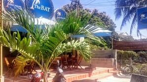 A guest house named "The BAY" with outdoor seating and a signboard. - The Bay Mui Ne (Mui Ne)