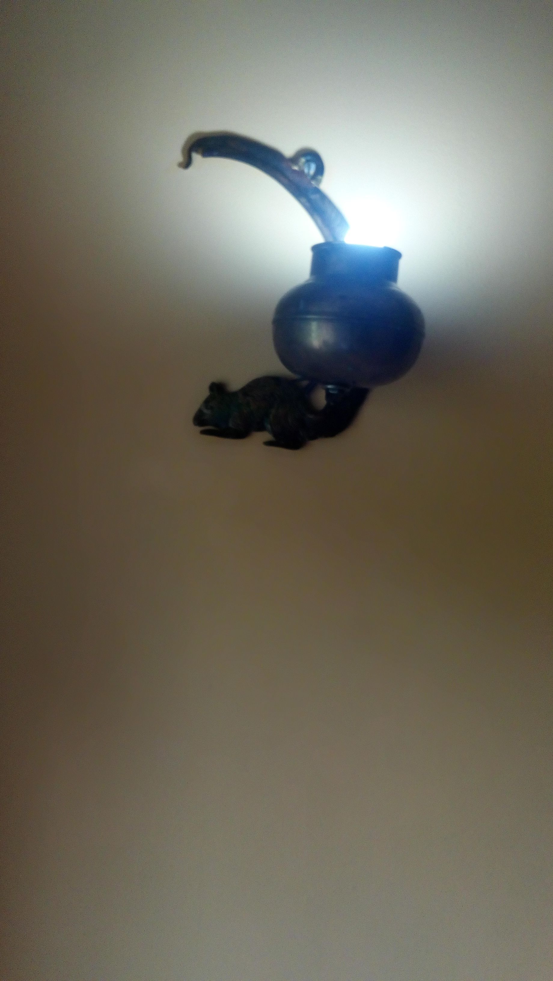 A ceiling-mounted light fixture with a curved design.