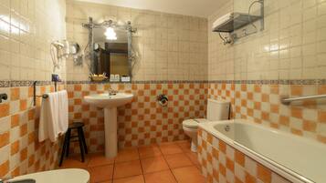 A bathroom with a sink, toilet, and bathtub.