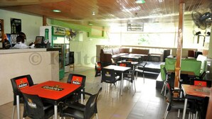 A restaurant with tables and chairs, a counter, and a view of the outdoors. - Koltol Guest House (Ibadan)