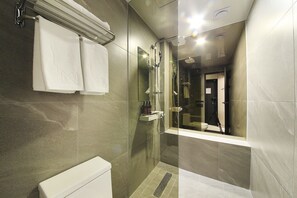 A modern bathroom with a glass-enclosed shower, a white toilet, and a mirror reflecting the interior. - Hotel yaja wirye (Seongnam)