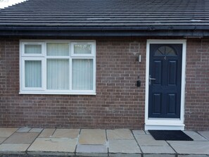 Traditional entrance with a classic knocker and intercom system.