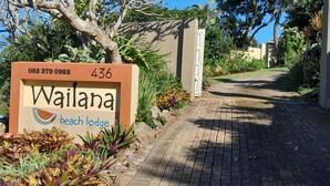 A sign for 'Wailana Beach Lodge' with a contact number and address. - Wailana Beach Lodge (Margate)