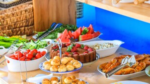 A buffet with various food items including tomatoes, watermelon, bread, and pastries. - Bahar Pansiyon (Kas)