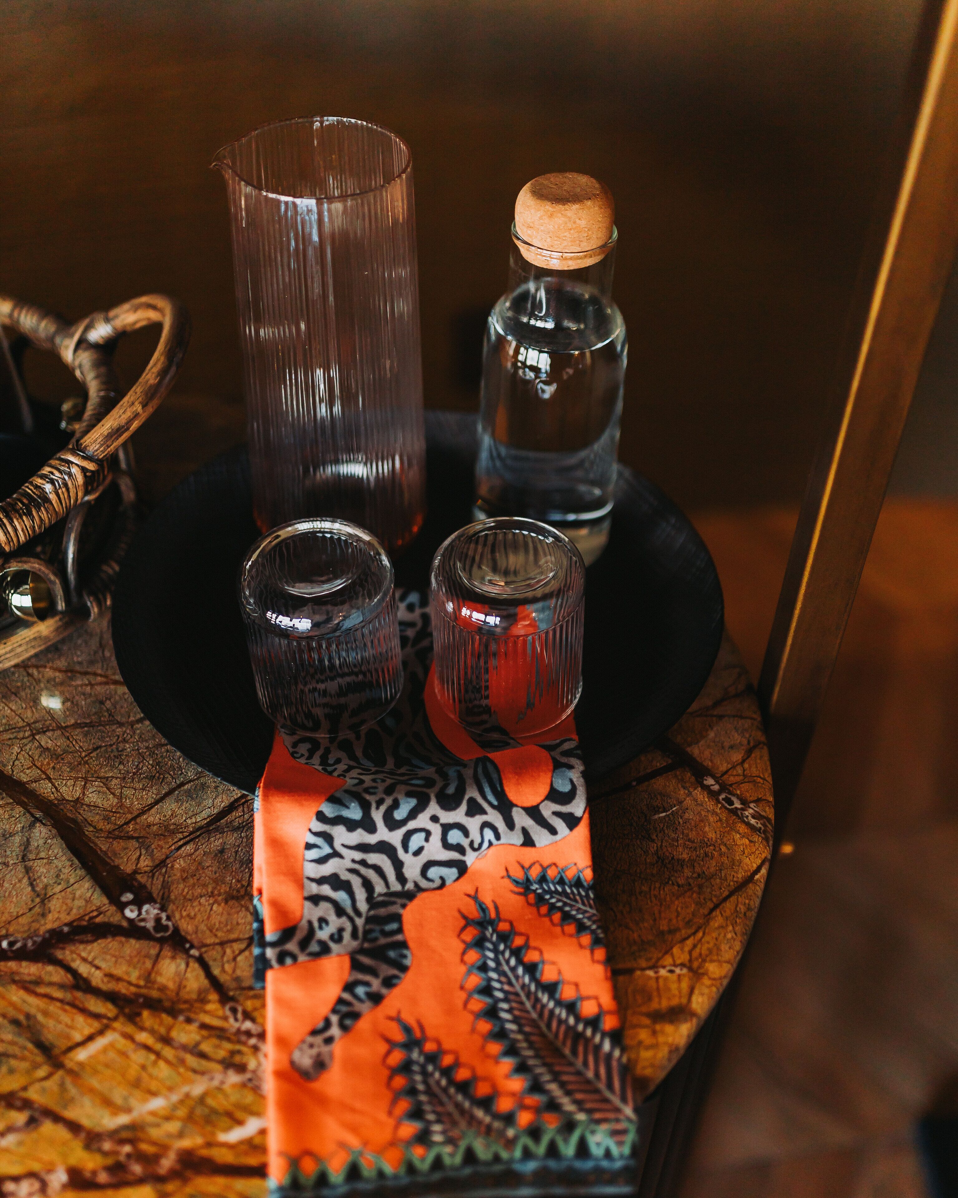 A table with various glassware and a decorative item.