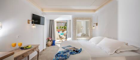 Habitación de hotel con cama, escritorio, ordenador portátil, televisión y vistas al exterior.