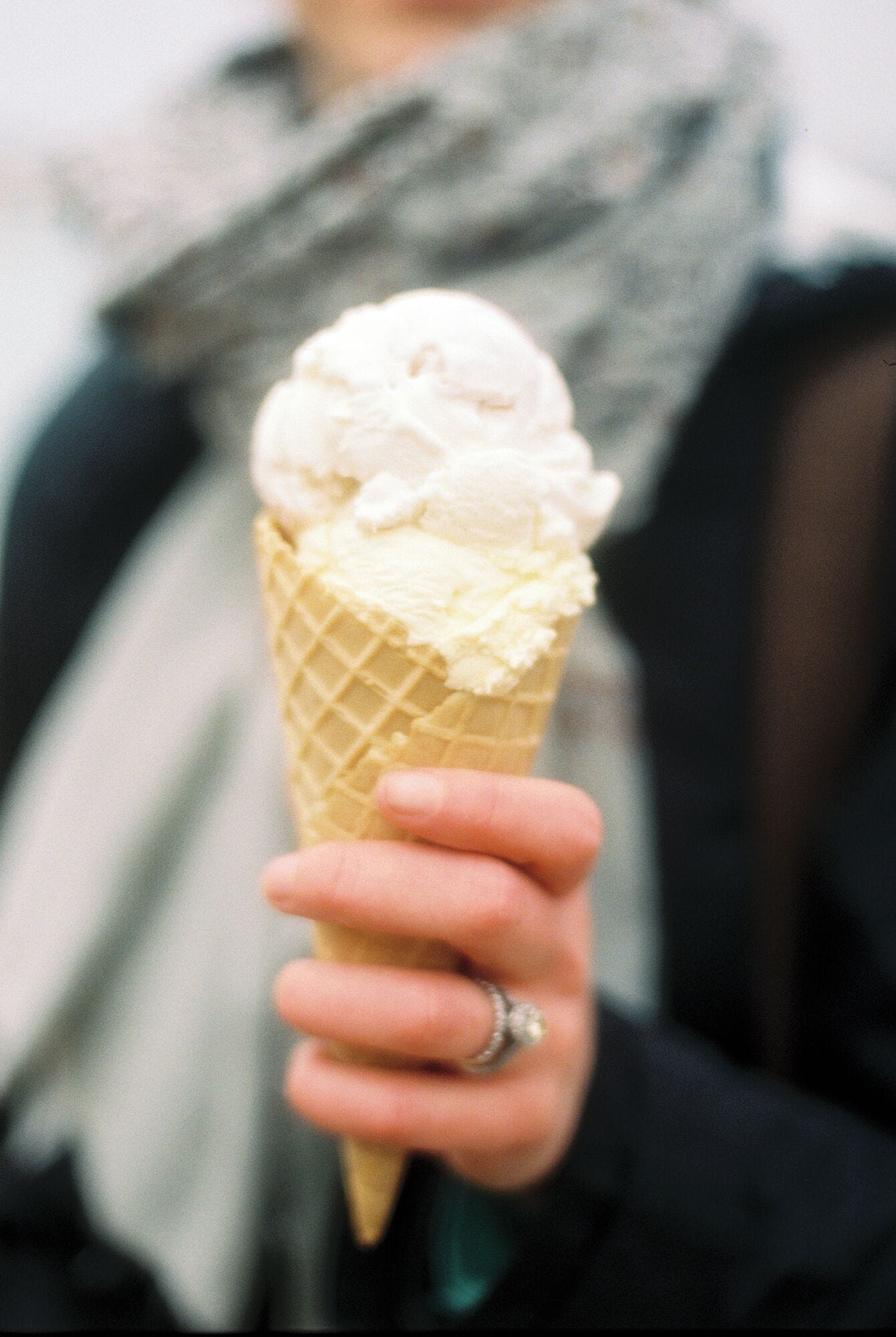 A person holding an ice cream cone.