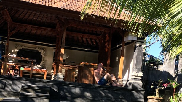 A traditional building with a tiled roof and wooden pillars.
