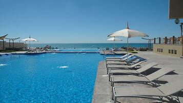 Outdoor pool, pool umbrellas, sun loungers