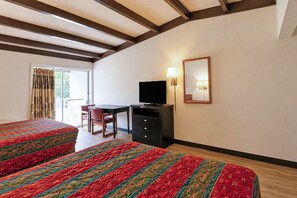 A hotel room with two beds, a desk with a television, a chair, and a mirror on the wall. - Hometown Inn Staunton VA near Hwy 11 (Staunton)