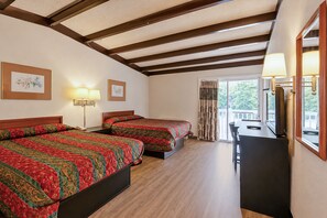 A hotel room with two beds, a desk, a TV, and a window with curtains. - Hometown Inn Staunton VA near Hwy 11 (Staunton)