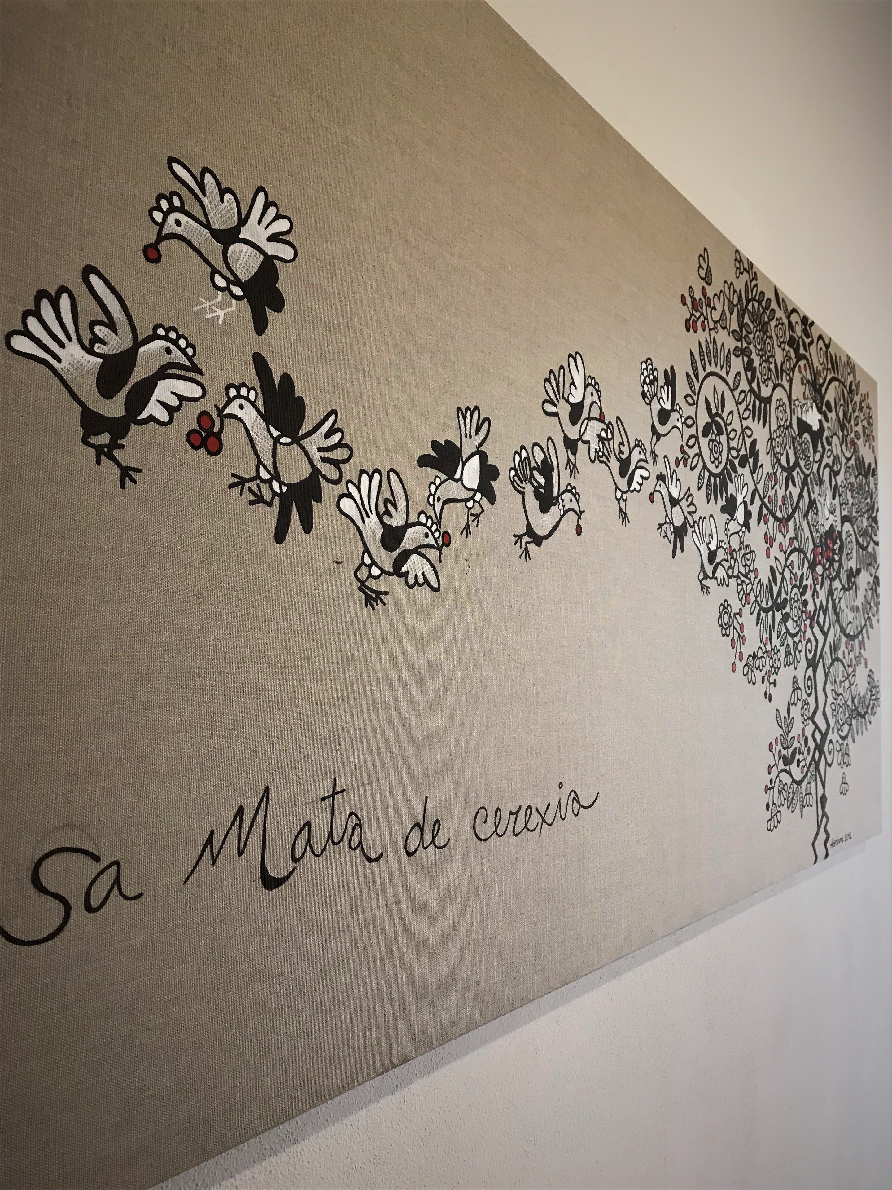Een muur met een muurschildering van vogels en bloemen.