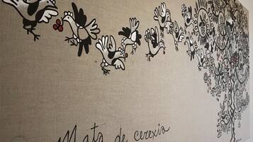 A wall with a mural of birds and flowers.